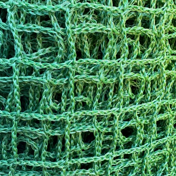 Close-up of a strong and lightweight polyethylene net. Ideal for securing loads, trailers, and containment areas